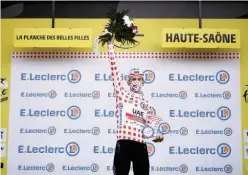  ?? Agence France-presse ?? ↑
UAE Team Emirates rider Adej Pogacar celebrates on the podium after winning the 20th stage of the 107th edition of the Tour de France cycling race on Saturday.