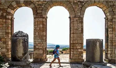  ?? — Photos: AFP ?? A tourist walks through the ruins of the ancient Roman site of Volubilis, near the town of Moulay Idriss Zerhounon in Morocco’s north central Meknes region.