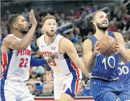  ?? JOHN RAOUX/AP PHOTOS ?? Magic swingman Evan Fournier (10) drives past the Pistons’ Glenn Robinson III (22) and Blake Griffin for a shot during the first half Wednesday night at Amway Center.