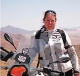  ??  ?? Photo shows Clickenger posing with her motorcycle in Namibia.