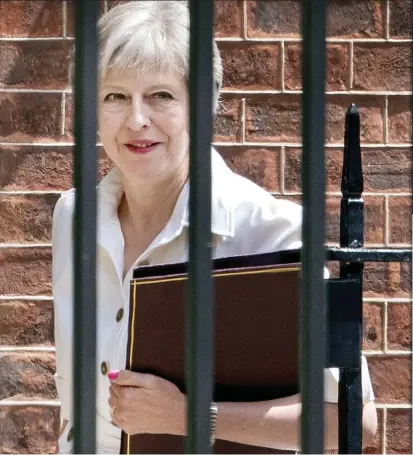  ??  ?? Alive to fight another day: Theresa May leaving Downing Street before yesterday’s vote