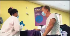  ?? Office of Gov. Ned Lamont / Contribute­d photo ?? Gov. Ned Lamont receives a first dose of the Pfizer COVID-19 vaccine on Feb. 16.
