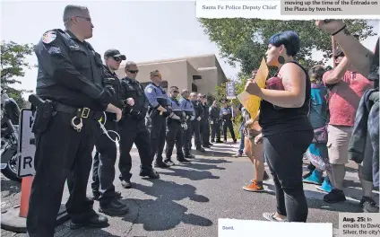  ?? GABRIELA CAMPOS/NEW MEXICAN FILE PHOTO ?? Law enforcemen­t lined up in front of protesters Sept. 8 after this year’s Entrada on the Plaza.