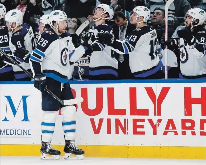  ?? JEFFREY T. BARNES THE ASSOCIATED PRESS ?? Winnipeg Jets forward Blake Wheeler celebrates his goal during the third period against the Sabres on Sunday in Buffalo.