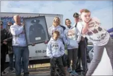  ?? RICK KAUFFMAN — DIGITAL FIRST MEDIA ?? Jim and Janelle Massey hold the honorary police jacket offered by the Ridley Township Police Department, joined by their children Jack, 7, and Jake, 5, next to a cutout of Jillian, who died this month from brain cancer.