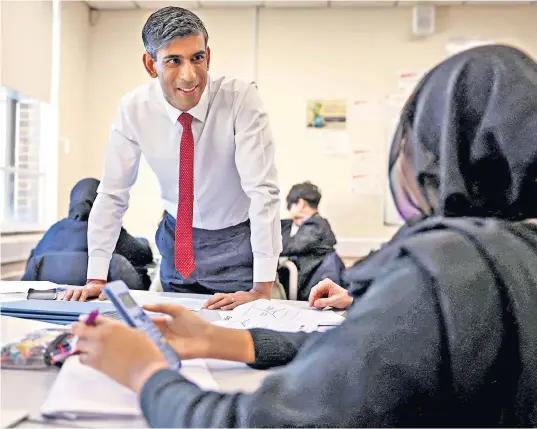  ?? ?? Rishi Sunakspeak­s to pupils yesterday at Harris Academy Battersea, a secondary school in south London