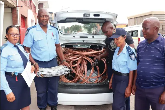  ?? (Picture: Andile Mahlala) ?? Nokuphiwa Zuma and security guards show stolen copper cord