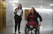  ?? ALEX BRANDON / ASSOCIATED PRESS ?? Sen. Tammy Duckworth (right), D-Ill., waits with an aide for the elevator on Capitol Hill last week in Washington. Duckworth doesn’t blend in with other senators, and that’s the way she likes it.