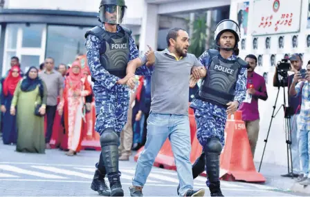  ??  ?? MALDIVIAN POLICE arrest a protester appealing for the release of opposition leaders held in jail in Male.