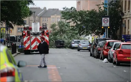  ??  ?? A fallen tree blocks Berkeley Street near the Gaelic school in the West End Pictures: Jamie Simpson