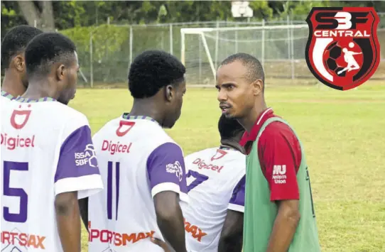  ?? (Photo: Paul Reid) ?? William Knibb Memorial football coach, Dewight Jeremiah (right) speaks to players during a break in their dacosta Cup match against Muschett High at Martha Brae on Wednesday.