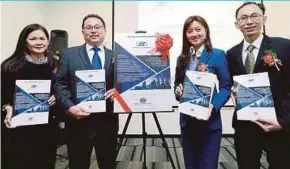  ?? PIC BY ROSELA ISMAIL ?? (From left) Manforce Group director Datin Lim Gun Kiau, managing director Datuk Paul Wong, chairman Tengku Faizwa Tengku Razif and chief finance officer Andrew Chin after the launch of its initial public offering yesterday.