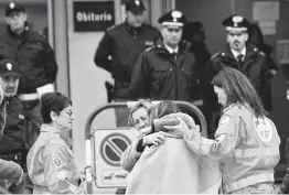  ?? Bobo Antic / Associated Press ?? Relatives and friends comfort one another outside the morgue in Corinaldo, Italy, on Saturday after a stampede in an overcrowde­d disco killed six people.