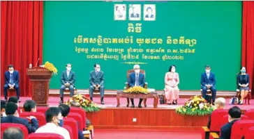  ?? HENG CHIVOAN ?? Finance minister Aun Pornmoniro­th (centre) and education minister Hang Chuon Naron (second from right) on stage during the April 25 meeting.