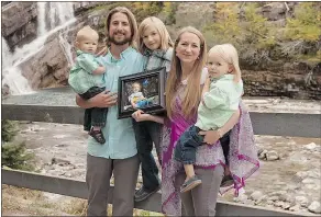  ?? — THE CANADIAN PRESS FILES ?? David and Collet Stephan pose with their children, Enoch, left, Ezra and Ephraim, while holding a photo of Ezekiel. The Stephans are on trial for failing to provide the necessitie­s of life to 19-month-old Ezekiel, who died in March 2012.