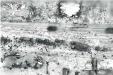  ?? — AFP photo ?? An image grab from a handout video released by the Israeli army shows what the army says are Gazans around aid trucks in Gaza City. Israeli forces shot dead 104 people when a crowd rushed towards aid trucks, the health ministry in Hamas-run Gaza said.