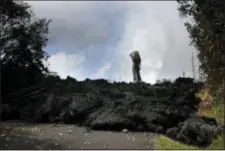  ?? JAE C. HONG — THE ASSOCIATED PRESS ?? Hannique Ruder, a 65-year-old resident living in the Leilani Estates subdivisio­n, stands on the mound of hardened lava Friday near Pahoa, Hawaii.