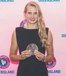  ??  ?? Harriet Brown with her award after being named Queensland Athlete of the Year, and right, in action on the beach.