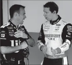  ?? JEFF SINER/TRIBUNE NEWS SERVICE ?? NASCAR driver Brad Keselowski, right, speaks with a crew member prior to the Daytona 500 on Feb. 25 at Daytona Internatio­nal Speedway in Daytona Beach, Fla.