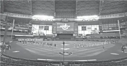  ?? MARK HOFFMAN / MILWAUKEE JOURNAL SENTINEL ?? The Milwaukee Brewers and Chicago White Sox stand for the national anthem before their game Monday night at Miller Park.