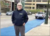  ?? ED WHITE — THE ASSOCIATED PRESS ?? Tony Sacco, co-owner of Mootz Pizzeria and Bar in Detroit, stands on Library Street near his restaurant