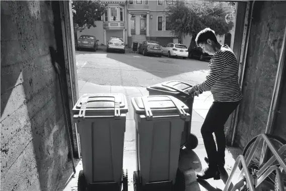  ?? Michael Macor / The Chronicle ?? TRASH TROUBLE: Marcy Fraser puts out one trash can for next-day pickup, but waits till early morning for the recycling because at night people go through it and make a mess.