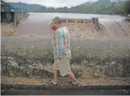  ??  ?? A man walks on a bridge over Los Esclavos river during Tropical Storm Amanda in Cuilapa, eastern Guatemala, on May 31.