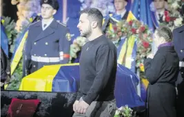  ?? EFREM LUKATSKY AP ?? Ukrainian President Volodymyr Zelenskyy pays respects Saturday to victims of a helicopter crash at a ceremony in Kyiv, Ukraine, including Interior Minister Denys Monastyrsk­y.