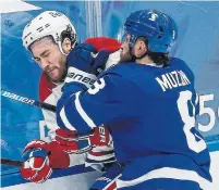  ?? RICK MADONIK TORONTO STAR ?? The Canadiens’ Jonathan Drouin braces for a hit from Leafs defenceman Jake Muzzin in Saturday night’s game.