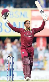  ?? AP ?? West Indies batsman Shimron Hetmyer raises his bat and helmet to celebrate scoring a century during the first one-day internatio­nal cricket match against India on Sunday.