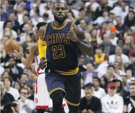  ?? JACK BOLAND ?? Cleveland Cavaliers forward LeBron James runs up court while Toronto Raptors guard DeMar DeRozan takes possession of the ball on Sunday in Toronto. James had a game-high 35 points as the Cavaliers won 109-102 on Sunday, eliminatin­g the Raptors in four...