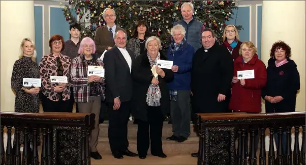  ??  ?? At the presentati­on of 4-Day Fast cheques in St. Iberius Church: Shona King (Collective Sensory Group), Frances Whelan and Jenna Murphy (It’s Good 2 Talk), Marjorie Mulligan (Hope Cancer Support Centre), Joe Costello (Wexford Hospice Homecare), Rev Arthur Minnion, Rita Codd (Fast helper), Annette Beckett and Brian MacGonagle (St Vincent de Paul), Peter Hudson (Fast helper), Fr Aodhan Marken), Aideen Moran (Ozanam House), Ethel Newton and Pauline Ennis (Wexford Women’s Refuge).