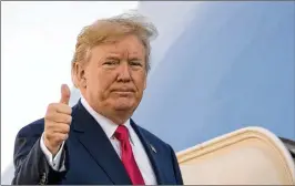  ?? ANDREW HARNIK / AP ?? President Donald Trump gives a thumbs-up Friday as he boards Air Force One at Andrews Air Force Base in Maryland. Trump is beginning a trip to Asia that includes stops in Japan, South Korea, China, Vietnam and the Philippine­s.