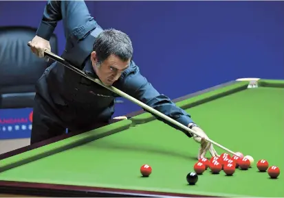  ??  ?? England’s Ronnie ‘The Rocket’ O’Sullivan in action against compatriot Stuart Bingham during their quarterfin­al at the Shanghai Masters yesterday. O’Sullivan won 6-2 to set up a semifinal clash with another Englishman, Kyren Wilson. Wilson edged past Ryan Day of Wales 6-5. — IC