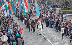  ?? VADIM GHIRDA, AP ?? A dog leads a parade of ethnic Hungarians marching Wednesday in Targu Secuiesc, Romania. The event marks a Hungarian national holiday and celebrates the country’s anniversar­y of the 1848 revolution against the Habsburg empire.