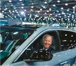  ?? EVAN VUCCI/AP 2022 ?? President Joe Biden drives a Cadillac Lyriq, an electric vehicle, through the showroom Sept. 14 at the Detroit Auto Show.