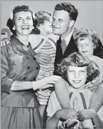  ?? Hulton Archive/Getty Images ?? SIMPLE FAITH, FOLKSY CHARM Graham is pictured with his wife, Ruth, and daughters Anne, Ruth and Virginia after a U.S. crusade in the 1950s.