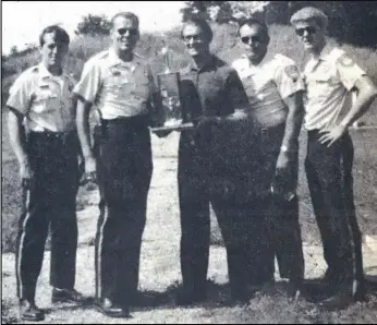  ?? EL File Photo ?? From July 23, 1971: The first place team in yesterday’s annual St. Marys Police Pistol Shoot for the Mayor’s Traveling Trophy was the St. Marys team comprised of (left to right) Patrolmen Tom Makley, Bill Grunden, Jack Kuenning and George Henderson. Mayor Opperman is in the center presenting the trophy to Grunden. The team won with a score of 1,543 of a possible 2,000.
