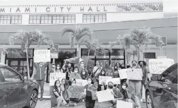  ?? Contribute­d to the Miami Herald ?? Activists with CLEO, a Miami-based group that addresses climate change, rallied in front of Miami City Hall to encourage commission­ers to fund the city’s resilience department in the new budget.