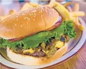  ?? NEW MEXICO TRUE ?? A Hatch green chile cheeseburg­er. The chiles are a staple of traditiona­l New Mexican cuisine.