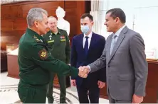  ?? AP ?? Russian Defense Minister Sergei Shoigu shakes hands with Libyan Prime Minister of the Government of National Unity Abdul Hamid Dbeibah in Moscow.