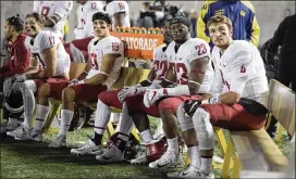  ?? D. ROSS CAMERON / AP ?? Washington State players, including QB Luke Falk (right), watch the stadium video screen during a 37-3 upset loss to Cal, their first loss of the season.