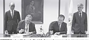  ?? DFA-OPCD/MARIA VANESSA UBAC ?? SECRETARY Manalo and Ambassador Kim ink the framework arrangemen­t.