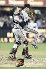  ?? — Photo by The Associated Press ?? San Francisco Giants’ starting pitcher Tim Lincecum gets lifted by catcher Buster Posey after his no-hit game against the San Diego Padres Saturday in San Diego. The Giants won the game 9-0. For Lincecum, it was his first career no-hitter and the...