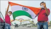  ?? PTI PHOTO ?? A girl along with her father holding the Tricolour to welcome the five Rafale combat jets at the Ambala airbase.