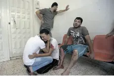  ?? MAHMUD HAMS/Agence France-Presse/Getty Images ?? Relatives of killed Palestinia­n Hatem Salem, 28, arrive at the al-shifa hospital in Gaza City, following an Israeli airstrike.
