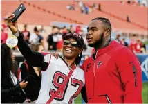  ?? CURTIS COMPTON / CCOMPTON@AJC.COM ?? Grady Jarrett takes a selfie with his mom, Lisa Jarrett, before playing in a wild-card game in January 2018. The franchise tag for Jarrett is projected to be about $14 million.