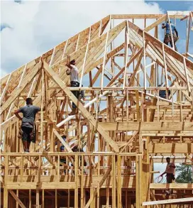  ?? Jason Fochtman / Houston Chronicle ?? Crews work on a new home. As the new home market is showing signs of slumping across the U.S. and locally, there are also indication­s that the impact of Hurricane Harvey will hurt sales by delaying new constructi­on or discouragi­ng people from buying.