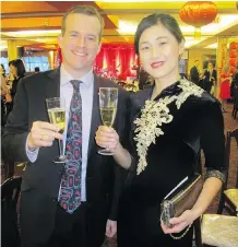  ??  ?? Toasting the 2018 Chinese New Year of the Dog are U.S. Consul General Tom Palaia and the Calgary Zoo’s Melody Song.
