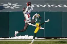  ?? Matt Ludtke / Associated Press ?? Mike Evans puts the jumping ability that made him an effective basketball player to use on a touchdown grab against the Packers.